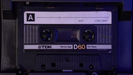Compact-Audio-Cassette-Tape-Playing-From-Start-in-Vintage-Deck-Player,-Close-Up