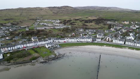 Aerial-Push-In-Port-Ellen-on-Islay,-Mountains-and-Countryside-in-Background