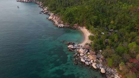 Drone-tilt-down-toward-beautiful-sandy-beach-on-tropical-island