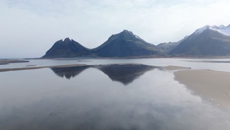 Three-mountains-reflected-in-Blue-Black-Rivers-Iceland-aerial-drone-natural-sky-formations-of-geological-nordic-mother-earth-landscape,-travel-destination