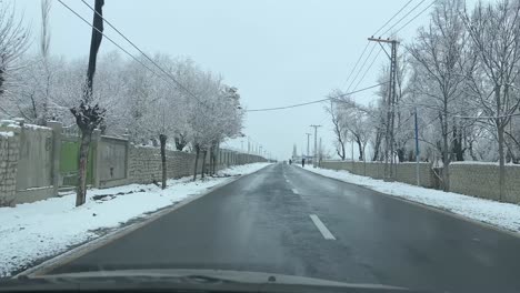 Auto-Fährt-Auf-Einer-Straße-In-Der-Stadt-Skardu-In-Einer-Schneebedeckten-Landschaft---Es-Ist-Bewölkt