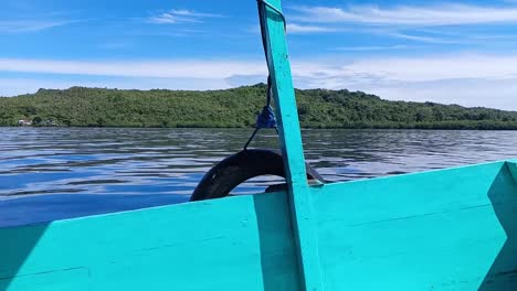 Boat-sails-in-the-sea-waters-on-Karampuang-Island,-Mamuju,-West-Sulawesi,-Indonesia