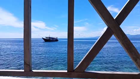 Boats-floating-on-the-ocean-on-Karampuang-Island,-Mamuju,-West-Sulawesi,-Indonesia