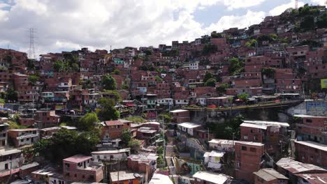 Hillside-patchwork-of-colorful-homes-in-Medellin's-Comuna-13,-Colombia---aerial