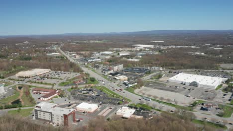 4K-Aerial-Drone-footage-of-industrial-shopping-centers-and-strip-malls-in-Middletown-New-York-and-traffics-can-be-seen-with-mountains-in-the-background