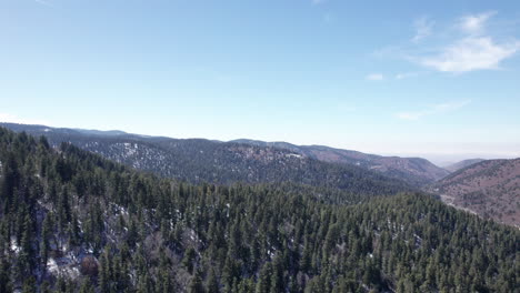 Aerial-view-push-in-of-the-pine-tree-forests-covering-the-mountains-in-New-Mexico