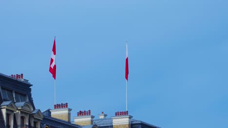 Swiss-flag-on-the-rooftop-in-Lausanne,-Switzerland