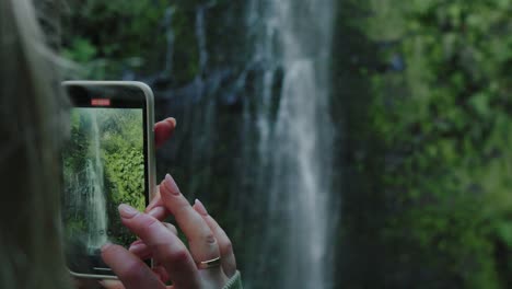 Girl-Taking-Photo-of-Large-Waterfall-in-Jungle,-Slow-Motion-4k