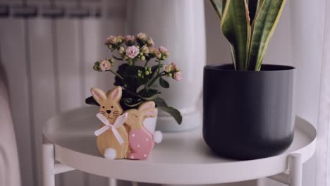 Charming-interior-decor-with-wooden-bunny-figurines-and-potted-plant