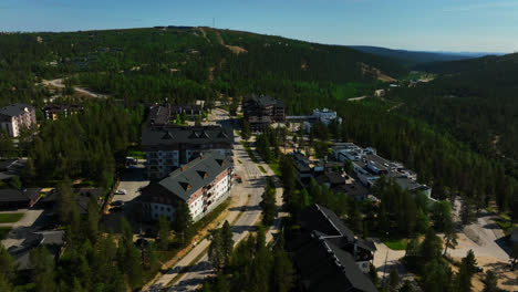 Drone-circling-hotels-in-the-Saariselka-town,-summer-day-in-Lapland,-Finland