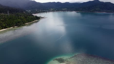 Port-Barton-Town-and-Bay-from-Above-Star-Fish-Shoal,-Drone-Reveal