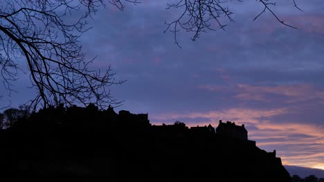 Silhouette-of-Edinburgh-Castle-at-sunset-on-a-winter's-night,-Scotland