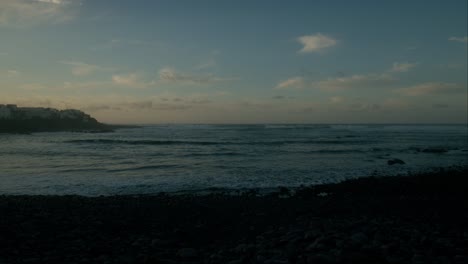 Blue-hour,-slowmotion-waves-on-beeble-beach-in-Playa-La-Caleta-de-Interián-on-Tenerife,-Canary-Islands