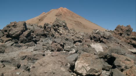 Volcanic-peak-of-Pico-del-Teide-behind-rocks-on-Tenerife,-Canary-Islands-in-spring