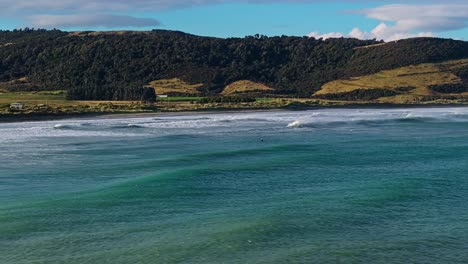 Aerial-panoramic-orbit-showcases-petrified-forest-and-ocean-water-of-Porpoise-bay