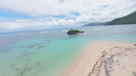 FPV-dynamic-flight-over-clear-water-of-Caribbean-sea,-coastline-and-sandy-beach-in-Samana,-Dominican-Republic
