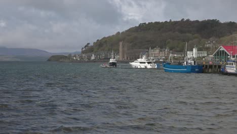 hand-held-shot-of-small-ferries-waiting-to-collect-passengers-from-Oban-harbour