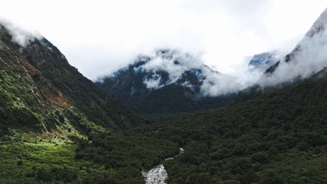 Aerial-panoramic-dolly-establishes-river-valley-of-Milford-Sound-with-stunning-clouds