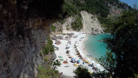Aerial-Traveling-Reveal-of-Agiofili-Beach-full-of-Tourists,-Lefkada,-Greece