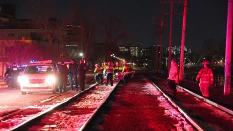 Police,-Firefighters-And-Emergency-Medical-Team-Rescued-Victim-In-Hypothermia-At-Night-In-Montreal,-Quebec,-Canada