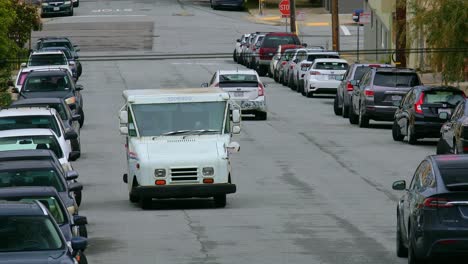 US-Postal-Delivery-Service-Van-Driving-Forward-and-Turning-in-a-Street-in-San-Francisco,-California,-USA