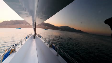 A-Sight-of-a-Boat-Nearing-the-Shore-of-the-Red-Sea,-Dahab,-Sinai-Peninsula,-Egypt---Slow-Motion