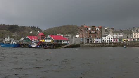 Hand-held-shot-of-a-small-ferry-waiting-to-collect-passengers-in-Oban