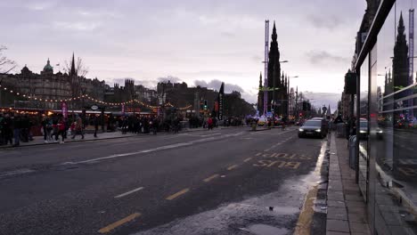 View-along-Princes-Street-Edinburgh-at-sunset-during-lead-up-to-New-Years-Eve,-Scotland