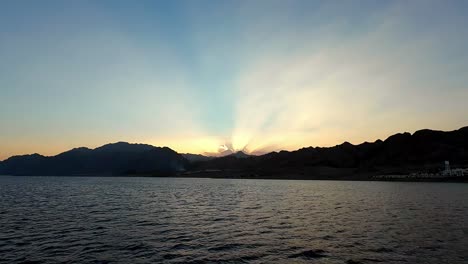 Mountains-In-Silhouette-At-Sunset-At-The-Laguna-Beach,-Dahab,-Egypt