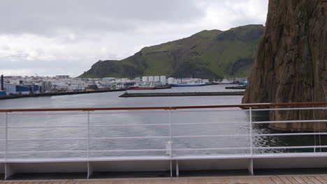 Back-of-Cruise-Ship-Leaving-Port-of-Vestmannaeyjar,-Heimaney,-Westerman-Islands,-Iceland