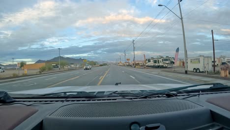 POV---Driving-on-Main-street-and-turning-left-into-the-parking-lot-for-Dollar-General-Store