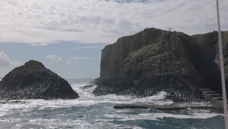 Hand-held-shot-of-large-waves-crashing-onto-the-jetty-at-the-Isle-of-Staffa