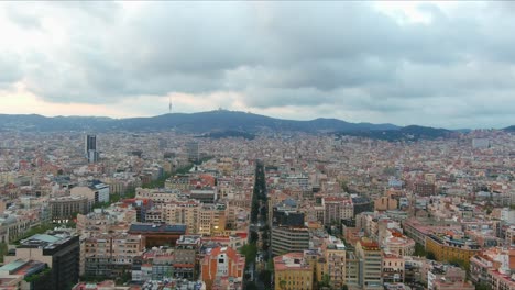 Barcelona-cityscape-with-overcast-skies,-dense-buildings-and-streets,-aerial-view