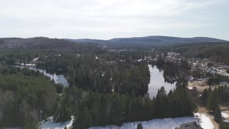 Saint-Côme-Quebec-aerial-footage-of-amazing-natural-landscape-with-pine-tree-forest-and-river-lake