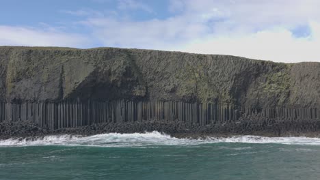 Dolly-shot-alongside-the-hexagonal-basalt-rocks-at-Fingals-Cave-at-Staffa