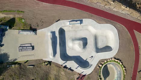 An-aerial-top-view-perspective-captures-Skatepark-Parque-das-Gerações,-situated-at-Estoril,-Portugal,-symbolizing-leisure,-fitness,-and-recreational-activities-for-free-time-enjoyment