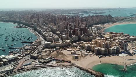 Aerial-view-showcases-the-coastal-residential-district-of-Alexandria,-a-Mediterranean-port-city-in-Egypt,-embodying-the-concept-of-seaside-living-and-maritime-charm