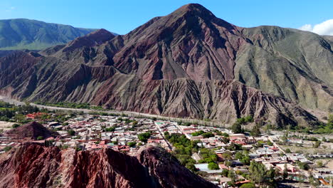 Panoramic-view-of-the-backside-of-Purmamarca-town-nestled-among-towering-mountains