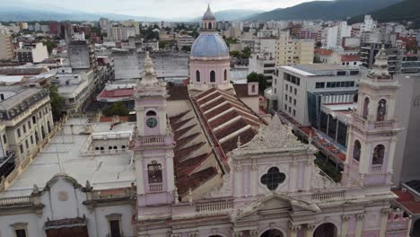 Aerial-pulls-back-from-blue-tile-dome-of-Cathedral-Basilica-in-Salta