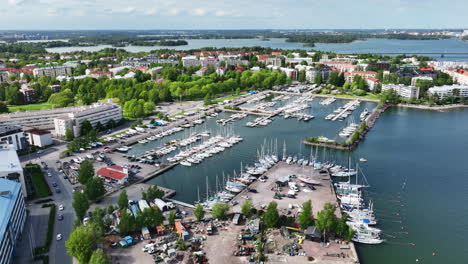 Drone-tilting-toward-the-Dromso-marina,-sunny-spring-day-in-Helsinki,-Finland