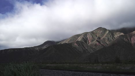 Timelapse-of-large-mountains-on-the-La-Quebrada-Humahuaca-tourist-train-route-in-Jujuy,-Argentina
