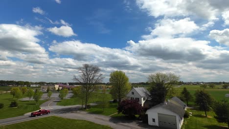 Fpv-drone-flight-over-farm-with-barn-and-storage-in-american-countryside-during-sunny-day