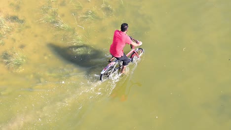 El-23-De-Abril-De-2024,-Un-Ciclista-Navegó-Por-Una-Carretera-Inundada-En-Los-Emiratos-Del-Norte-De-Los-Emiratos-Árabes-Unidos-Tras-Unas-Lluvias-Récord-En-El-País.