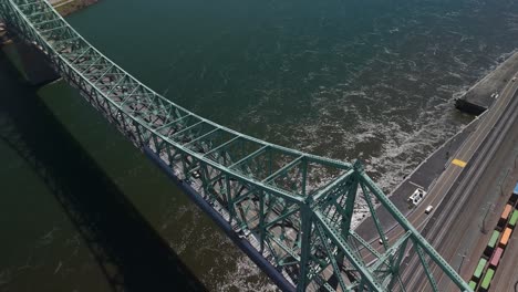 drone-rotate-around-The-Jacques-Cartier-Bridge-steel-truss-cantilever-bridge-crossing-the-Saint-Lawrence-River-from-Montreal-Island,-in-Quebec-Canada-famous-landmark