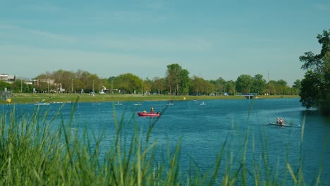 Vibrant-lakeside-activities-at-Jarun-Lake-in-Zagreb,-with-kayaking-and-rowing-teams-in-action