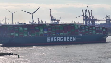Evergreen-G-class-Container-Ship-Sailing-At-Nieuwe-Waterweg-With-Wind-Turbines-In-The-Background-In-Hook-of-Holland,-Netherlands