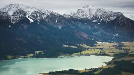 A-lake-with-turquoise-waters-lies-at-the-foot-of-the-snow-topped-mountain-range