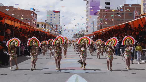 Gold-dresses-and-ornate-headdresses-on-Carnival-dancers,-Oruro-parade