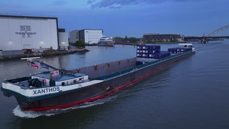 Empty-Xanthos-Cargo-Ship-Sailing-Across-The-Noord-River-In-Alblasserdam,-Netherlands