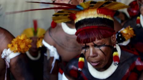 Tribal-forest-people-with-facial-paintings-and-colorful-headdresses-are-dancing